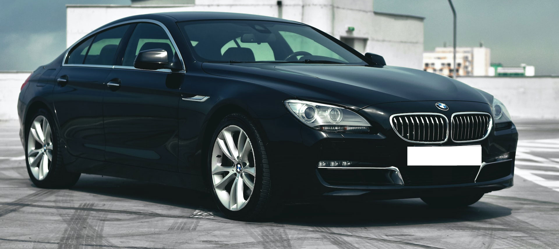 black bmw car parked on car park