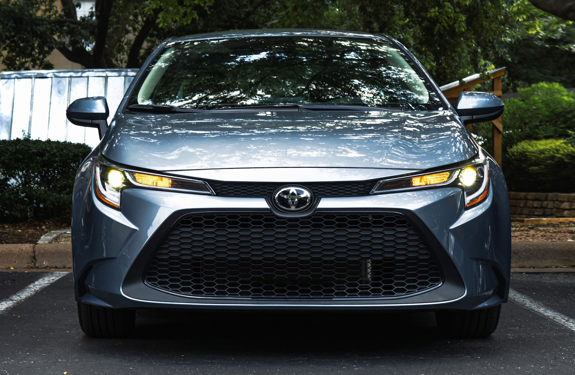 Grey-Toyota-car Grey Toyota car with headlights on